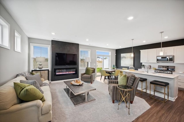2154 Tyrone Dr, Shakopee, MN 55379 - living room featuring dark wood-style floors, recessed lighting, and a large fireplace