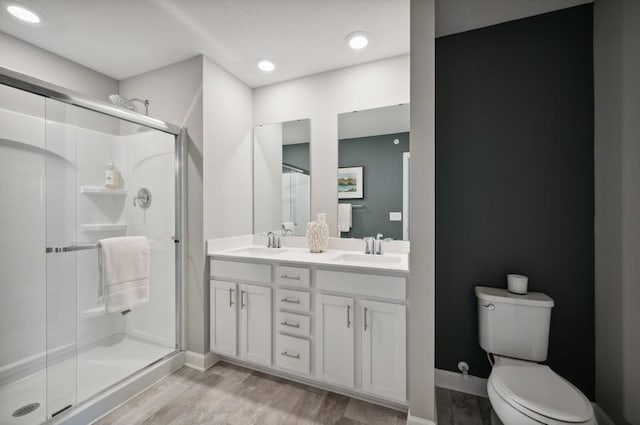 2154 Tyrone Dr, Shakopee, MN 55379 - full bath with toilet, a stall shower, double vanity, wood finished floors, and baseboards