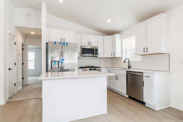 2354 Jandell Ave NE, Saint Michael, MN 55376 - kitchen featuring stainless steel appliances, vaulted ceiling, plenty of natural light, light wood-style floors, and backsplash