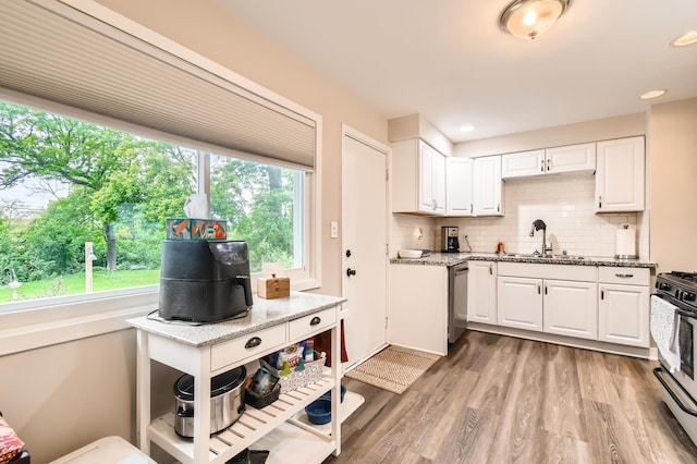 4989 Turtle Ln W, Shoreview, MN 55126 - kitchen featuring a sink, white cabinetry, stainless steel appliances, tasteful backsplash, and recessed lighting