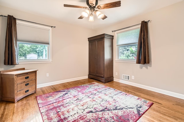 4989 Turtle Ln W, Shoreview, MN 55126 - bedroom with light wood-style flooring, baseboards, and a ceiling fan