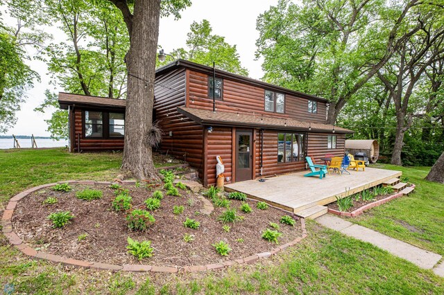 41780 Kansas Point Ln, Pelican Rapids, MN 56572 - back of property featuring faux log siding, a wooden deck, and a yard