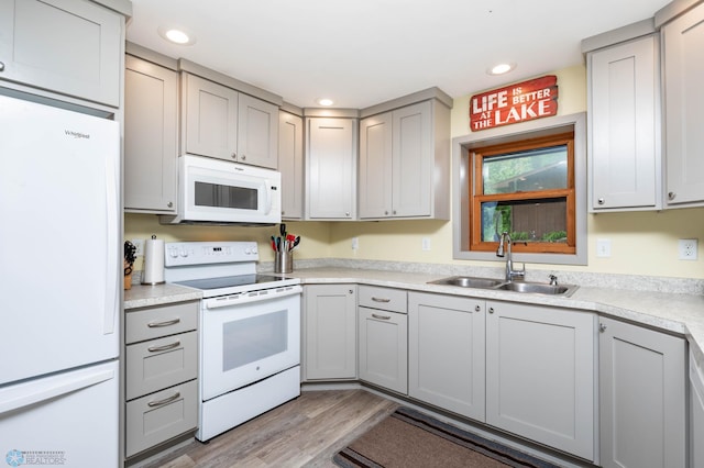 41780 Kansas Point Ln, Pelican Rapids, MN 56572 - kitchen featuring white appliances, a sink, light wood-style flooring, gray cabinetry, and recessed lighting