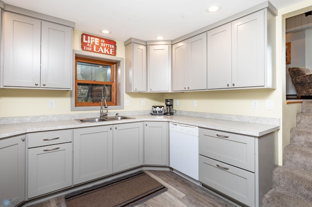 41780 Kansas Point Ln, Pelican Rapids, MN 56572 - kitchen with white dishwasher, a sink, light wood-style flooring, light countertops, and recessed lighting