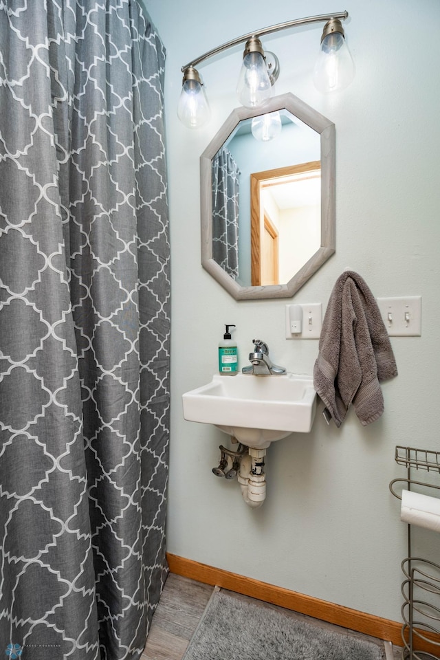 41780 Kansas Point Ln, Pelican Rapids, MN 56572 - full bath featuring baseboards, wood finished floors, and a sink