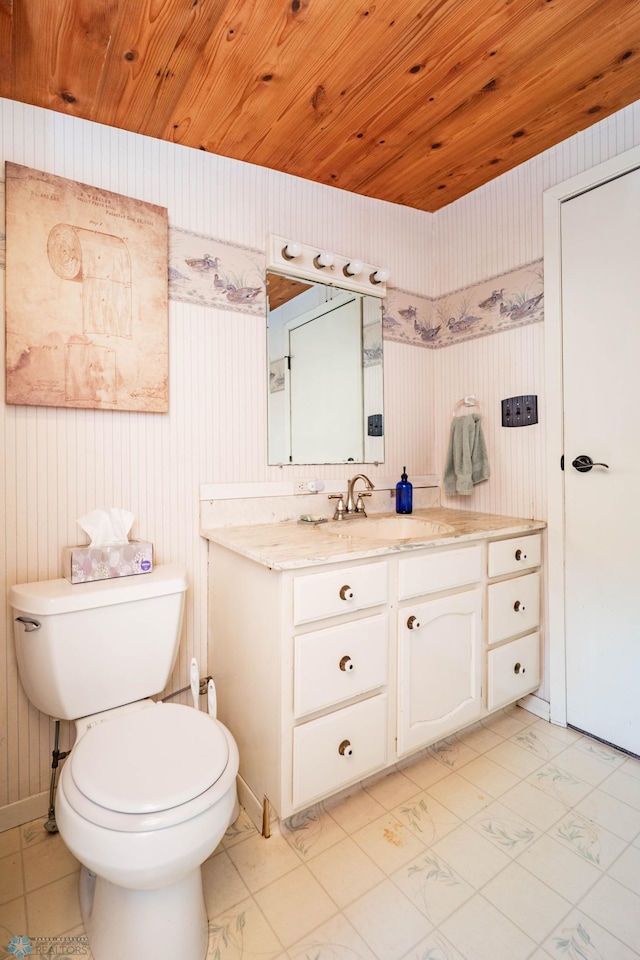 41780 Kansas Point Ln, Pelican Rapids, MN 56572 - bathroom with toilet, vanity, baseboards, wood walls, and wood ceiling