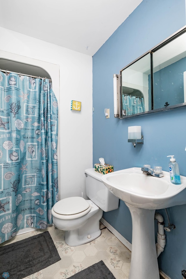 41780 Kansas Point Ln, Pelican Rapids, MN 56572 - bathroom featuring toilet, baseboards, and curtained shower