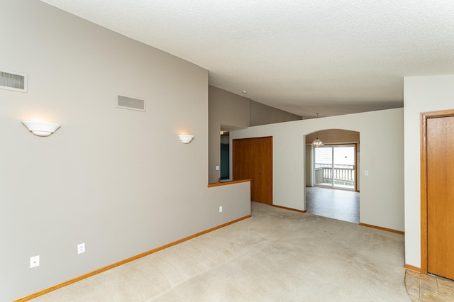 2225 Fisher Ct NW, Rochester, MN 55901 - spare room featuring lofted ceiling, light carpet, and a textured ceiling