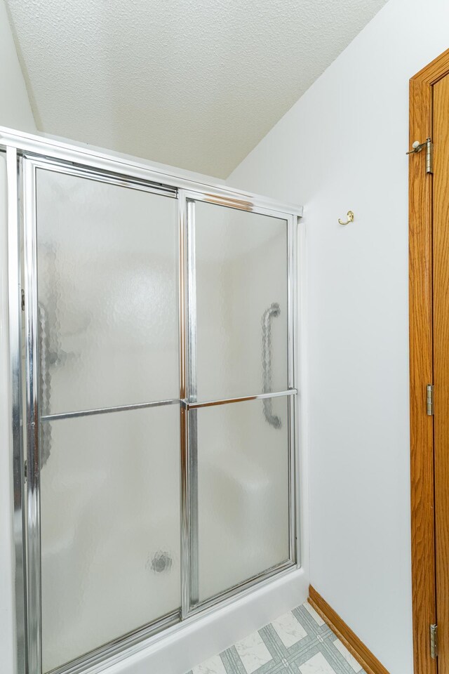 2225 Fisher Ct NW, Rochester, MN 55901 - bathroom with a shower with door and tile patterned floors