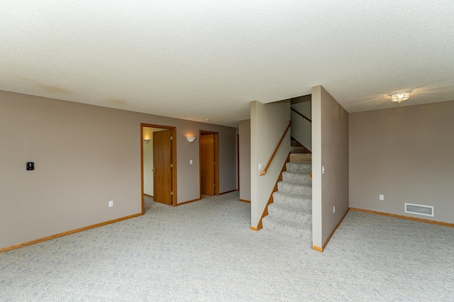 2225 Fisher Ct NW, Rochester, MN 55901 - spare room with light colored carpet, stairs, and a textured ceiling