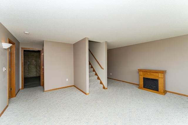 2225 Fisher Ct NW, Rochester, MN 55901 - unfurnished living room featuring carpet, stairs, a glass covered fireplace, and a textured ceiling