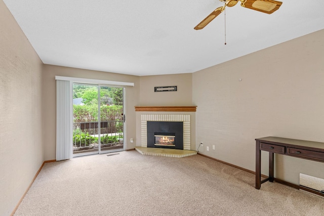 2310 Benson Ave Unit H, Saint Paul, MN 55116 - unfurnished living room featuring ceiling fan, carpet flooring, a brick fireplace, and baseboards