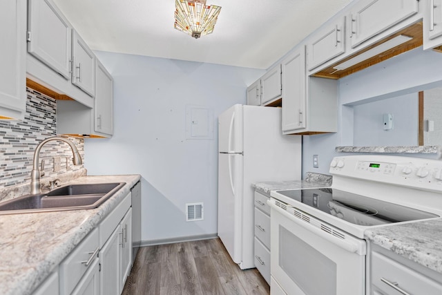 2310 Benson Ave Unit H, Saint Paul, MN 55116 - kitchen featuring white range with electric cooktop, a sink, light wood-style flooring, backsplash, and light countertops