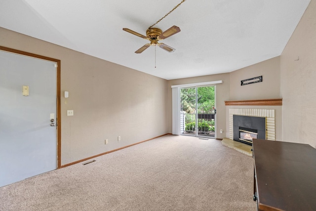 2310 Benson Ave Unit H, Saint Paul, MN 55116 - unfurnished living room with carpet flooring, a ceiling fan, a fireplace, and baseboards