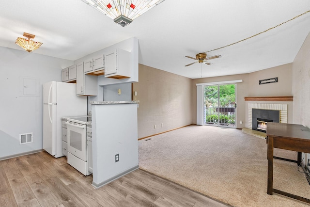 2310 Benson Ave Unit H, Saint Paul, MN 55116 - kitchen with white appliances, baseboards, a fireplace, light wood-style flooring, and a ceiling fan