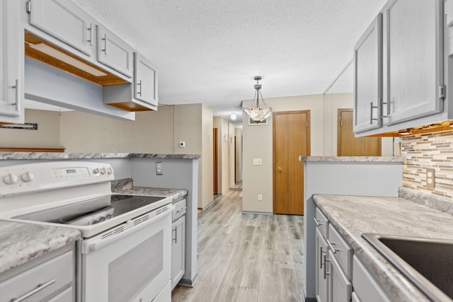 2310 Benson Ave Unit H, Saint Paul, MN 55116 - kitchen with electric range, light wood-style flooring, light countertops, gray cabinetry, and a textured ceiling
