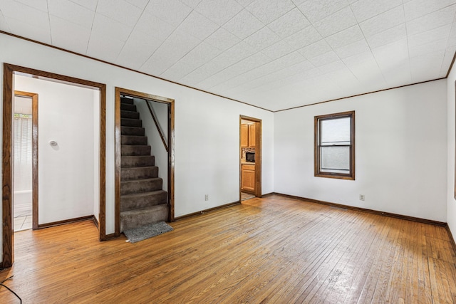 917 Jessie St, Saint Paul, MN 55130 - unfurnished room featuring light wood finished floors and stairs