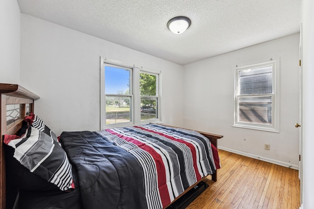 917 Jessie St, Saint Paul, MN 55130 - bedroom with wood-type flooring and a textured ceiling