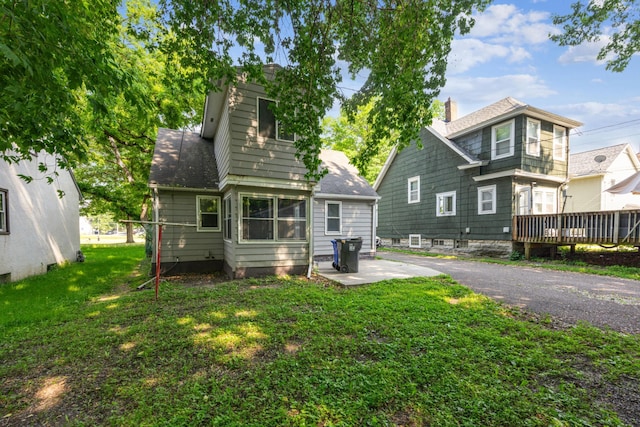 917 Jessie St, Saint Paul, MN 55130 - back of property with a yard, a shingled roof, and a chimney