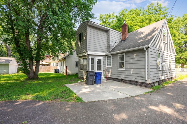 917 Jessie St, Saint Paul, MN 55130 - rear view of property featuring a patio area, a chimney, and a shingled roof