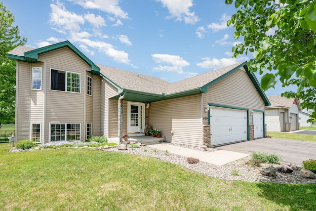 509 8th Ave SE, Isanti, MN 55040 - view of front facade featuring a front lawn, an attached garage, driveway, and roof with shingles