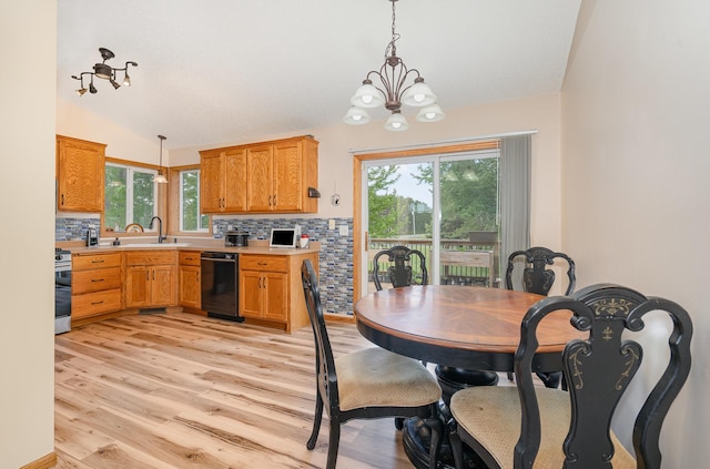 509 8th Ave SE, Isanti, MN 55040 - dining room with lofted ceiling, light wood-type flooring, a chandelier, and healthy amount of natural light
