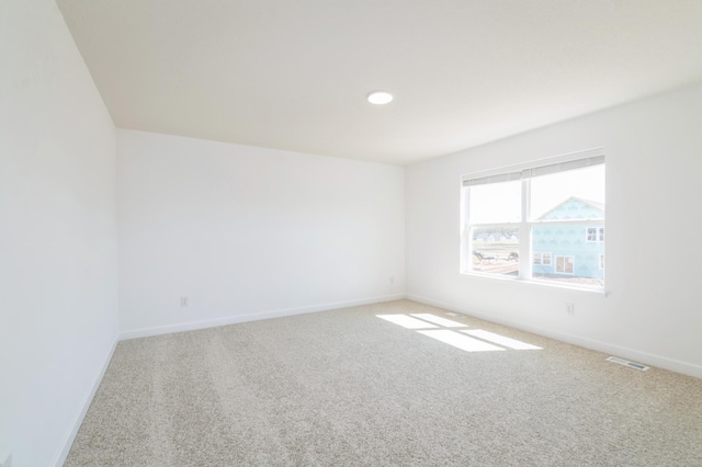 empty room with carpet and baseboards