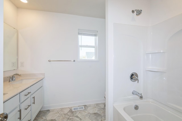 bathroom with double vanity, tub / shower combination, and baseboards