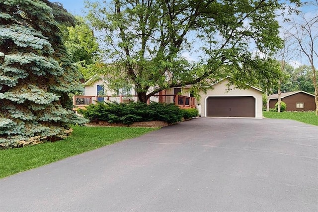 13993 Crosstown Blvd NW, Andover, MN 55304 - view of property hidden behind natural elements featuring asphalt driveway and an attached garage