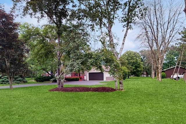 13993 Crosstown Blvd NW, Andover, MN 55304 - view of grassy yard featuring asphalt driveway and an attached garage