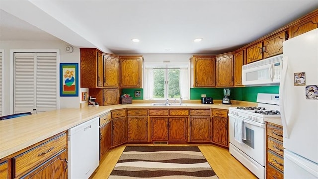 13993 Crosstown Blvd NW, Andover, MN 55304 - kitchen featuring white appliances, light wood-type flooring, brown cabinetry, light countertops, and recessed lighting