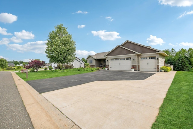 106 Prairie Grass Dr, Osceola, WI 54020 - view of side of property with an attached garage, asphalt driveway, and a lawn