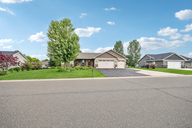 106 Prairie Grass Dr, Osceola, WI 54020 - view of front of home featuring a garage, driveway, a front lawn, and a residential view