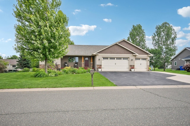 106 Prairie Grass Dr, Osceola, WI 54020 - craftsman inspired home featuring a garage, asphalt driveway, a front yard, and stone siding