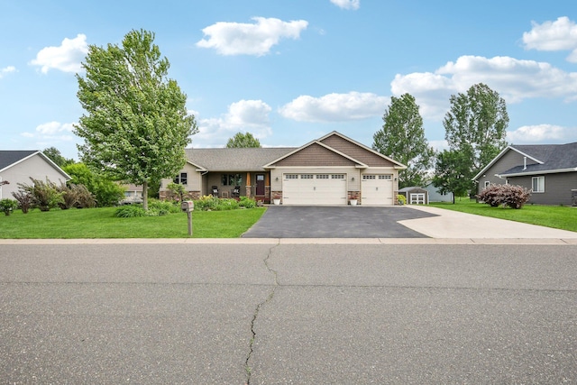 106 Prairie Grass Dr, Osceola, WI 54020 - view of front facade featuring a garage, a front lawn, and asphalt driveway