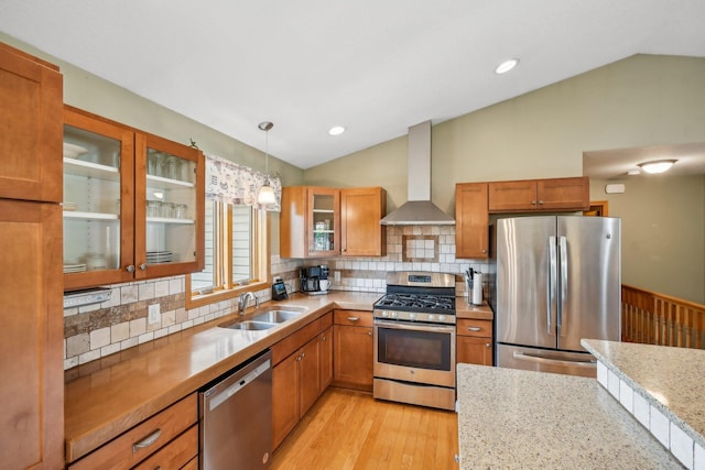 106 Prairie Grass Dr, Osceola, WI 54020 - kitchen with appliances with stainless steel finishes, lofted ceiling, wall chimney exhaust hood, brown cabinetry, and backsplash
