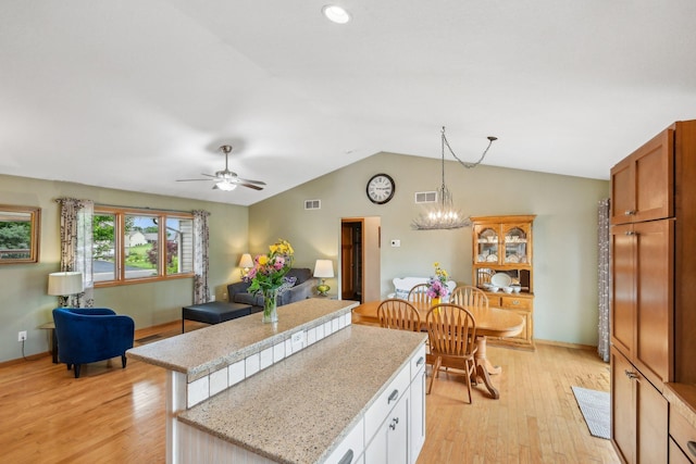 106 Prairie Grass Dr, Osceola, WI 54020 - kitchen featuring a center island, light wood-style flooring, lofted ceiling, decorative light fixtures, and a ceiling fan