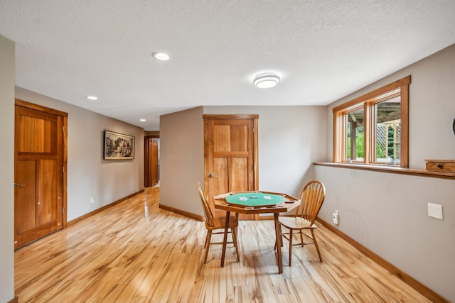 106 Prairie Grass Dr, Osceola, WI 54020 - dining room with light wood-style floors, a textured ceiling, and recessed lighting