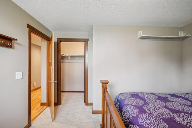 106 Prairie Grass Dr, Osceola, WI 54020 - bedroom featuring carpet floors, a spacious closet, a closet, and a textured ceiling