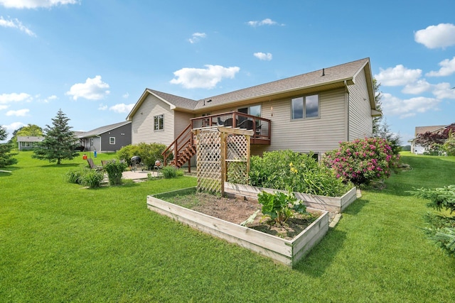 106 Prairie Grass Dr, Osceola, WI 54020 - rear view of property featuring a vegetable garden, stairs, a wooden deck, a lawn, and a patio area