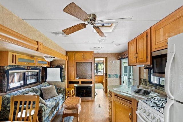 5181 Fish Hook Dr SW Unit 44, Lake Mary Twp, MN 56308 - kitchen with white appliances, ceiling fan, light wood finished floors, open floor plan, and light countertops