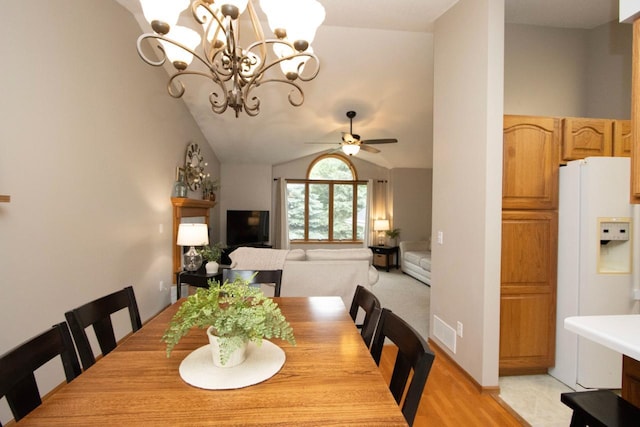 2109 Haughton Ave, North Mankato, MN 56003 - dining area with a chandelier, ceiling fan, lofted ceiling, and light wood-type flooring