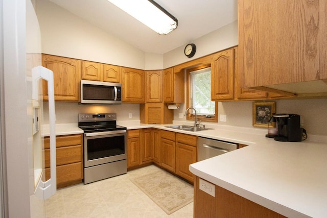 2109 Haughton Ave, North Mankato, MN 56003 - kitchen with appliances with stainless steel finishes, a sink, vaulted ceiling, light countertops, and brown cabinetry