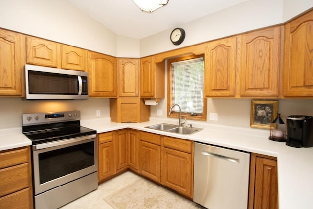 2109 Haughton Ave, North Mankato, MN 56003 - kitchen featuring appliances with stainless steel finishes, a sink, light countertops, and vaulted ceiling