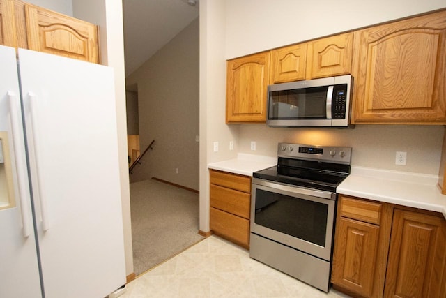 2109 Haughton Ave, North Mankato, MN 56003 - kitchen featuring appliances with stainless steel finishes, vaulted ceiling, and light countertops