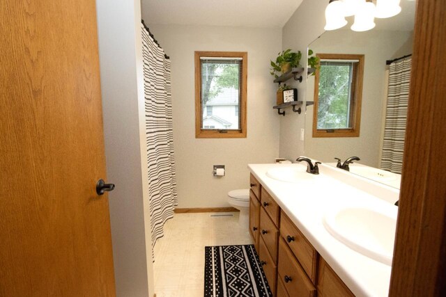 2109 Haughton Ave, North Mankato, MN 56003 - full bathroom featuring double vanity, tile patterned floors, a chandelier, and plenty of natural light