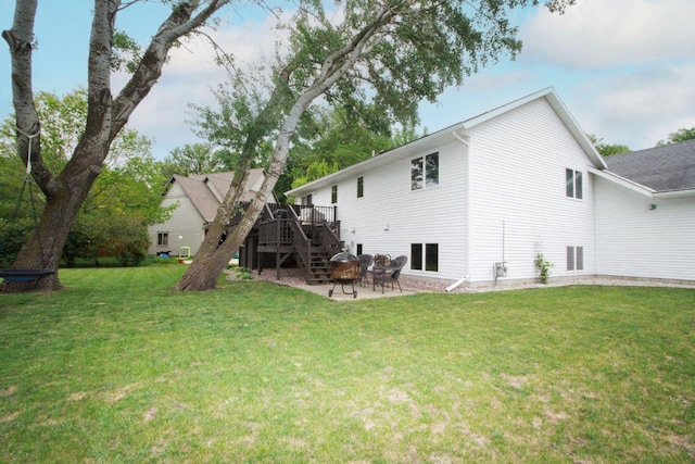 2109 Haughton Ave, North Mankato, MN 56003 - rear view of house featuring a wooden deck, stairs, a patio area, and a lawn