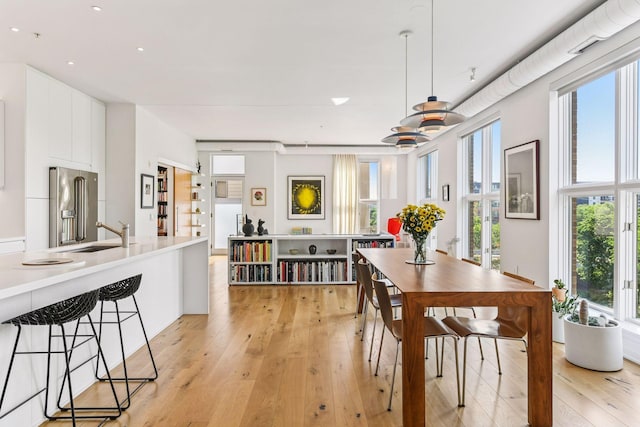 2845 Colfax Ave S Unit W305, Minneapolis, MN 55408 - dining room featuring light wood finished floors, plenty of natural light, and recessed lighting