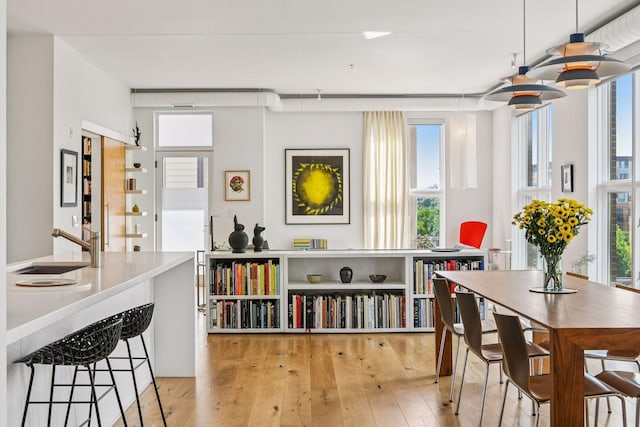 2845 Colfax Ave S Unit W305, Minneapolis, MN 55408 - dining space with light wood-style flooring and healthy amount of natural light