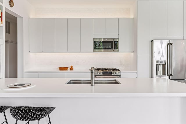 2845 Colfax Ave S Unit W305, Minneapolis, MN 55408 - kitchen with stainless steel appliances, a sink, light countertops, and modern cabinets